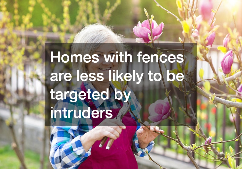 elderly woman pruning trees in a yard with fencing